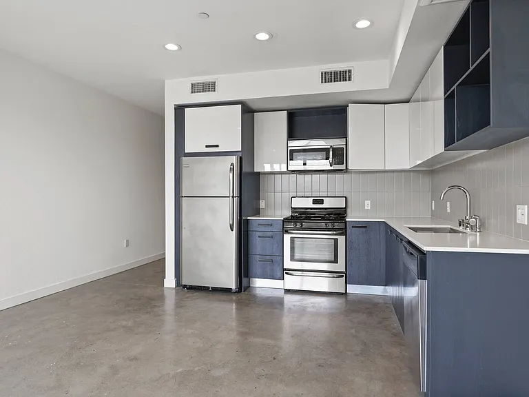 Modern Kitchen with Blue Cabinetry and Stainless-Steel Appliances