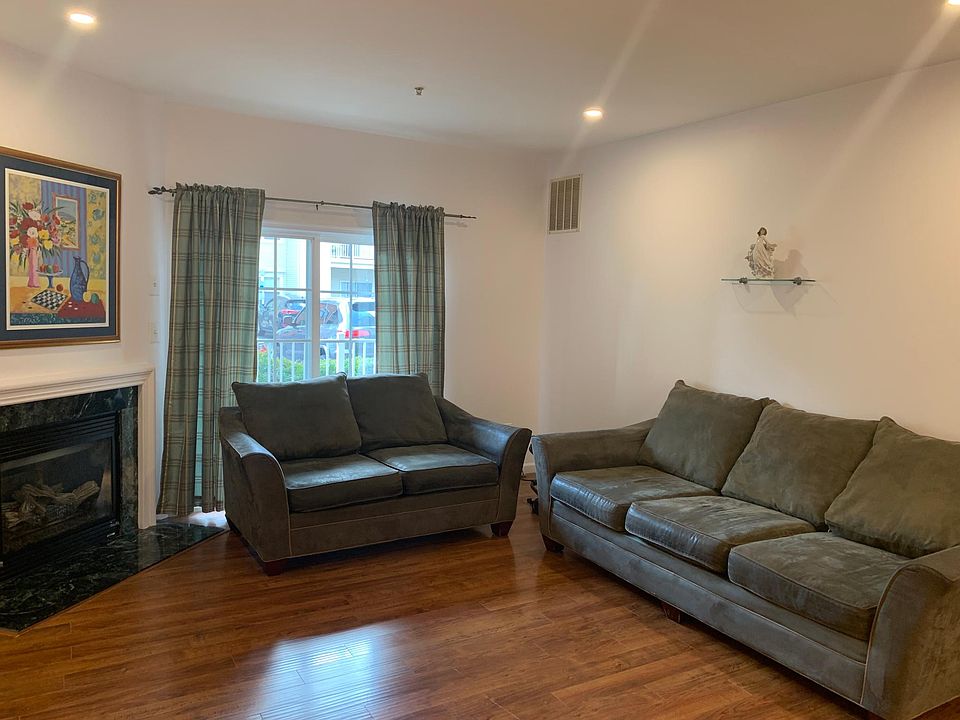 Living Room with Recessed Lights, Sofas, Curtains and professional Art