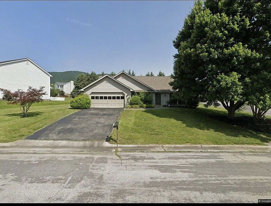Front with old garage door.