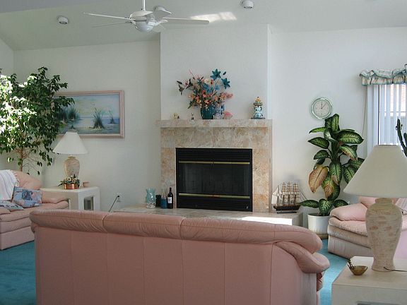 Vaulted Great Room with sliders, skylights, recessed lighting, fireplace
