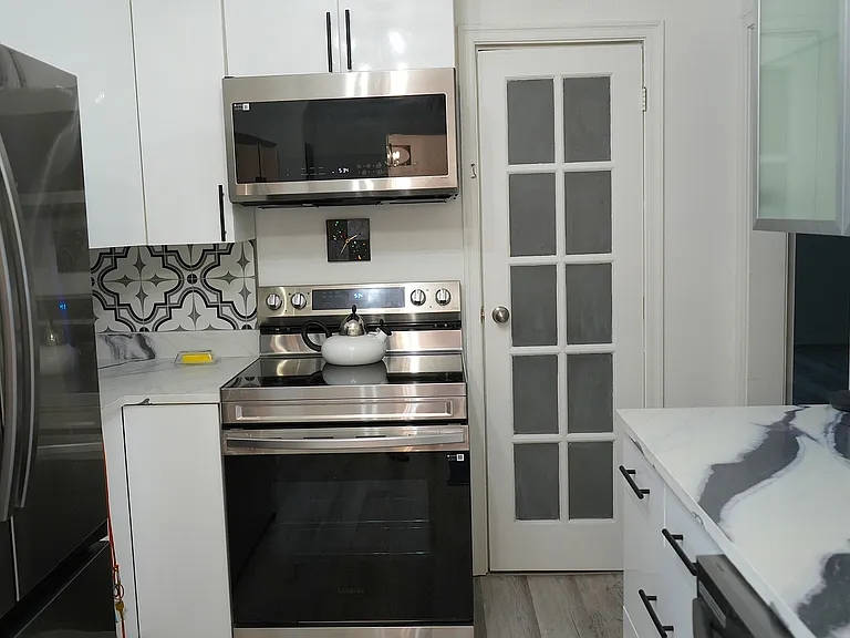 Kitchen - door opens to full pantry