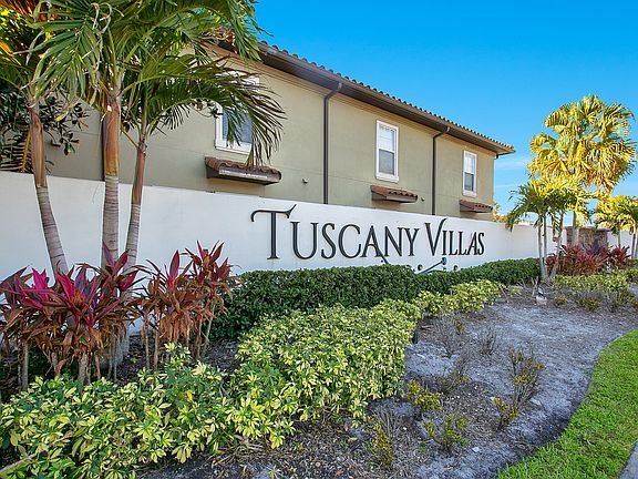 apartment building signage reading "Tuscany Villas"