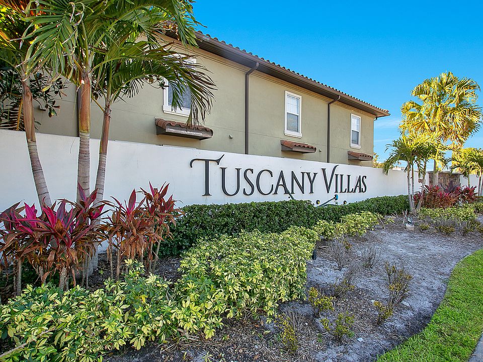 apartment building signage reading "Tuscany Villas"