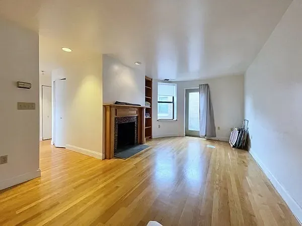Living room. View from dining area towards doorway to balcony.