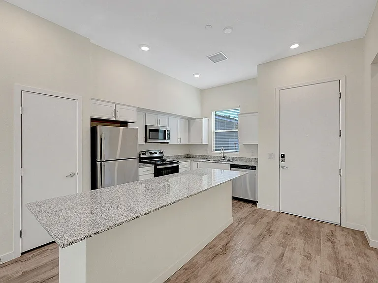 Step into a stylish kitchen featuring top-of-the-line appliances and elegant granite finishes.