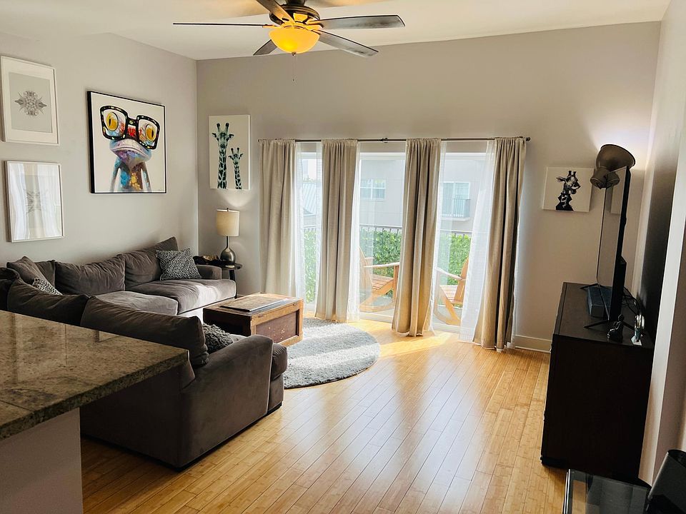Huge open living room, natural light from south looking over pool. The most desirable location quiet off of the hustle and bustle of Central and all that The Edge District has to offer.