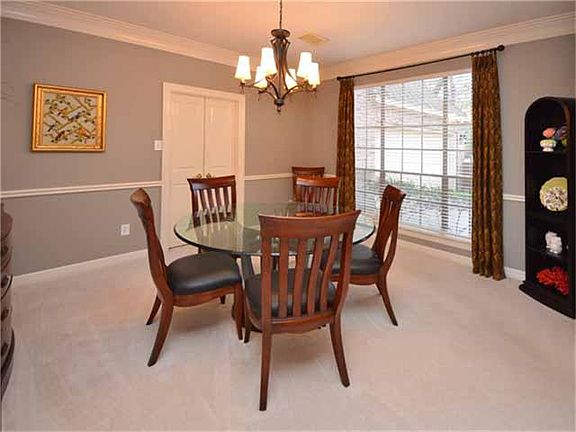 Notice the crown molding in this bright and cheery dining room which overlooks the front yard.