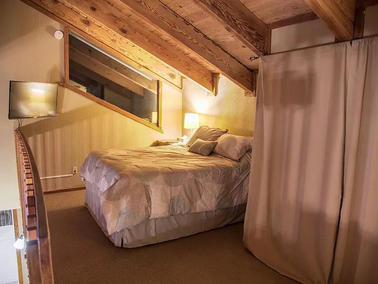 Queen bed in the loft. Washer and dryer to the right.