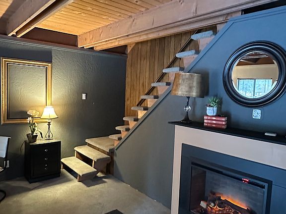 Livingroom, electric fireplace, stairs