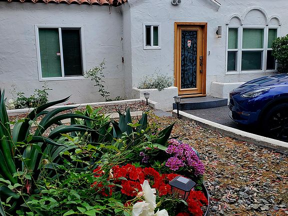 Lovely and private and gated front yard and driveway area.