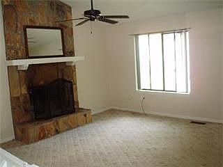 Great room featuring stone fireplace.