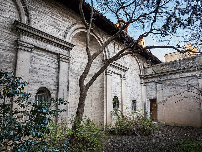 Before: Architectural accents of archway on exterior of building. Now a stunning garden courtyard!
