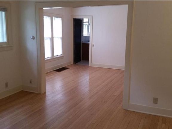 Standing in living room, looking into dining room with kitch