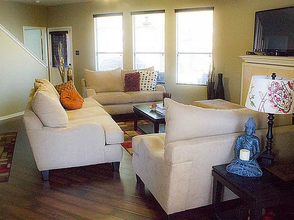 As you enter this beautiful home, spacious living area with laminate wood flooring and travertine fi