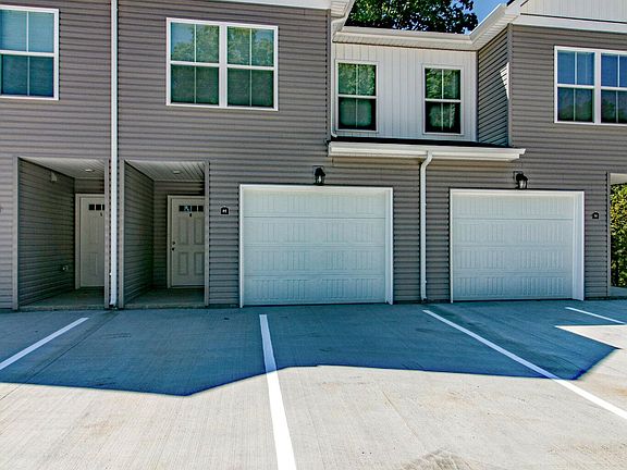 Front of Condo with Private Entrance and 1 Car Garage with 2 parking spaces in front of entry.