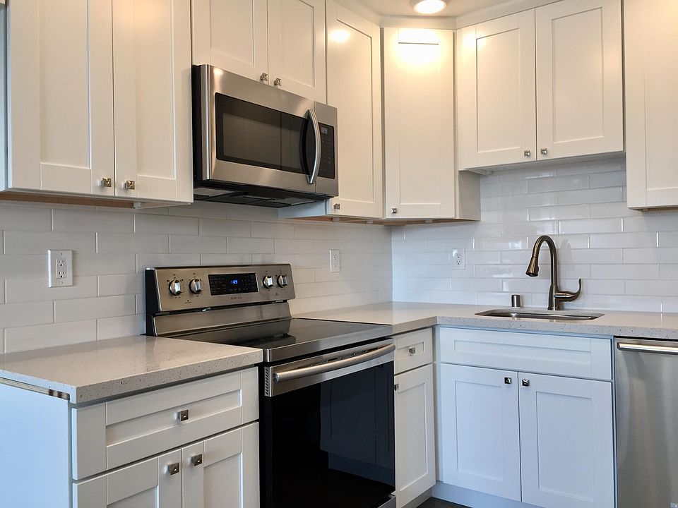 Completely updated kitchen with new quartz counters, Stainless steel appliances under mount sink and subway tile back splash.