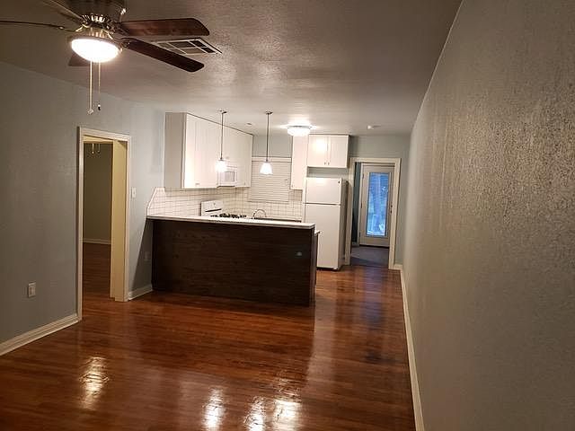 From living room, looking into kitchen, showing back door.