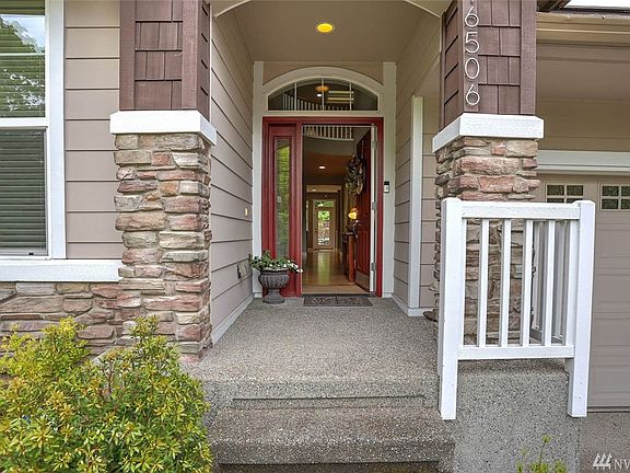 Beautiful craftsman home with gorgeous rock on the entrance pillars and lower portion of the front of the home, as well as impressive two-story entrance.