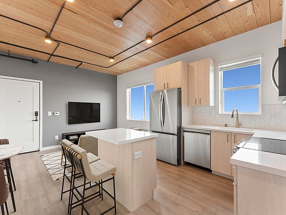 Experience modern living in this sleek apartment kitchen, combining style with functionality.