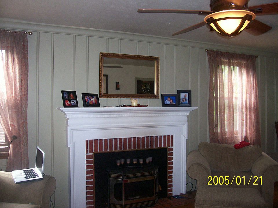 Fireplace with removeable pellet stove in living room.