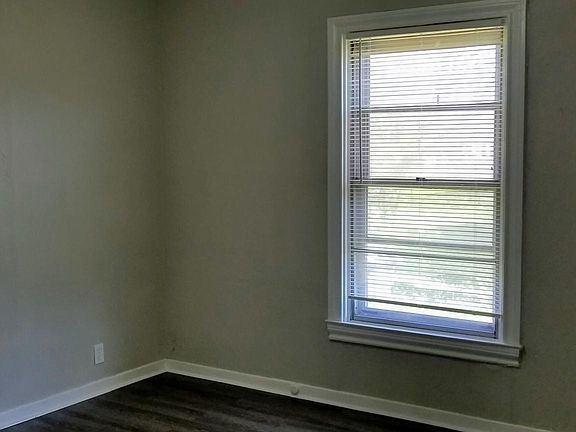 One of three bedrooms each with its own closet.