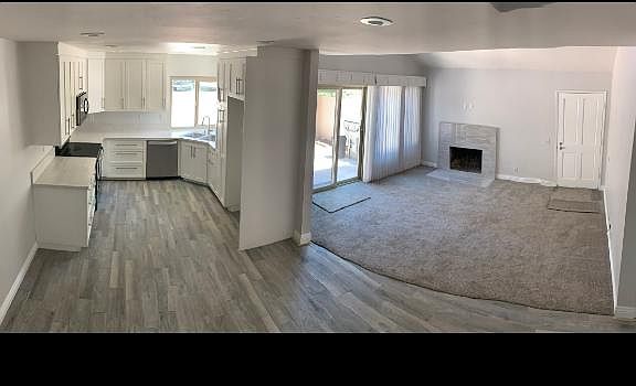 Kitchen, Dining Room and Living Room with double pane windows and slider. Retitled modern fireplace.