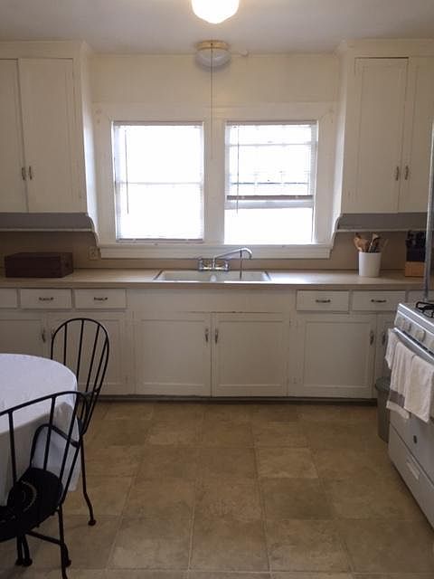 Large eat-in kitchen with stove and refrigerator and great cabinet space.