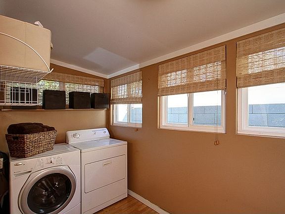 The adjoining spacious laundry room features a large pantry