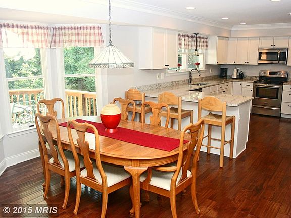 Kitchen has table space in bright bay window