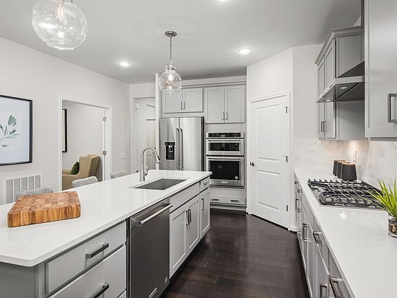 Arctic White Quartz Countertops and Stainless Steel Appliances in the Gourmet Kitchen