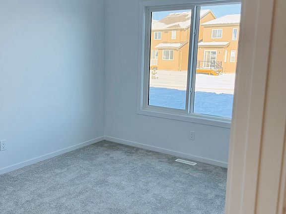 Spacious bedroom on main floor, with big windows