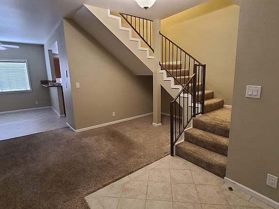 Living/ Dining area with stairs to 2nd level.