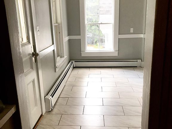 Large porcelain tile floor with space for breakfast area