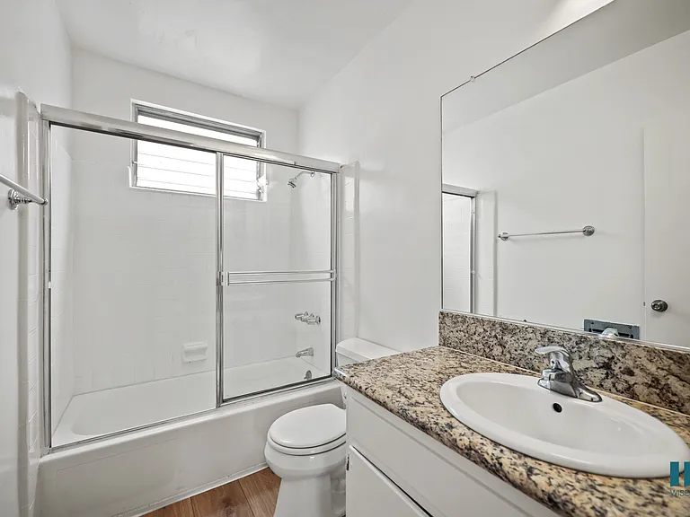 Bathroom with Shower bath with a Glass Door and Vanity Cabinet Storage