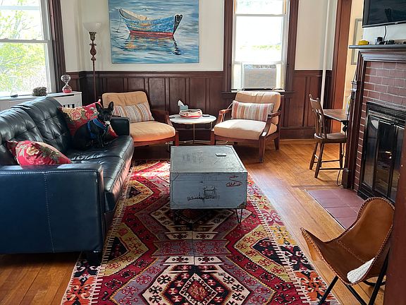 Living room. Leather sofa, comfy chairs, smart tv (wifi included), games, books