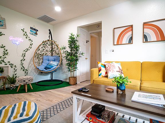 Living room features everything you need to kick back and relax: an Instagramable "egg chair" corner; a sofa that can be pulled out to a comfortable twin bed; 55 inch smart TV with Roku System; and plenty of board games.