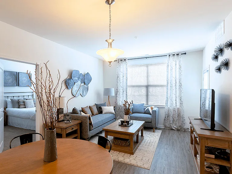 Modern, cozy living spaces with stylish decor, luxury flooring, and warm wood accents for a welcoming feel.