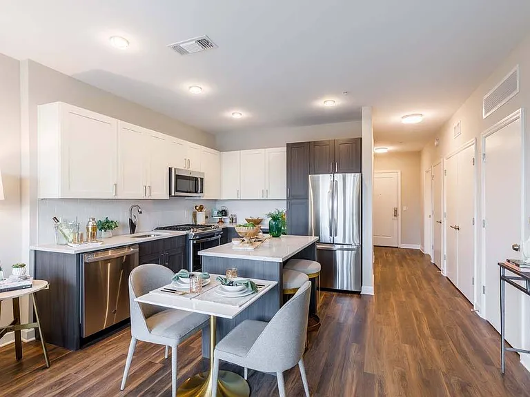 Two-toned cabinetry with upgraded kitchen features including Kitchens including a separate wine fridge and double-door refrigerator*