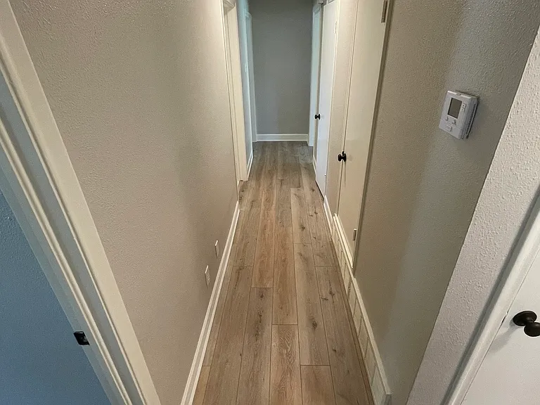Hallway which has two large closets (also has a closet for water heater and AC unit)