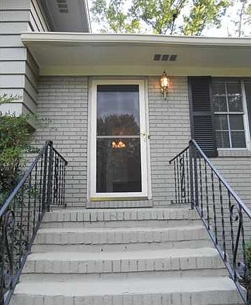 Glass storm door offers lots of light which makes a welcoming entrance.