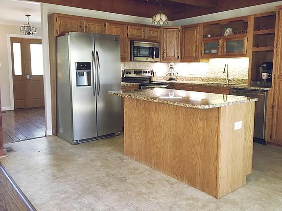 Granite countertops, island, under cabinet lighting, stainless steel appliances