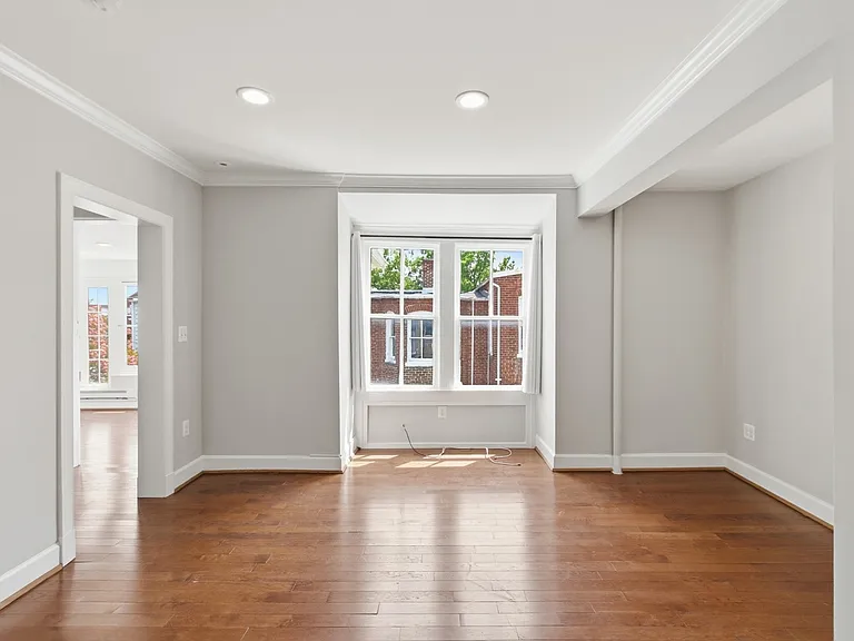 Living Room with entry to the left to two rooms at the back of the house: 1 bedroom and the sunroom.