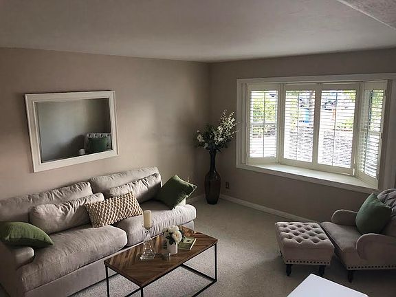 Den with bay window facing the street