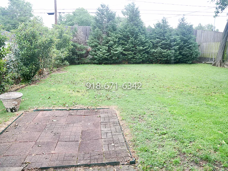 Large, landscaped and fenced back yard.