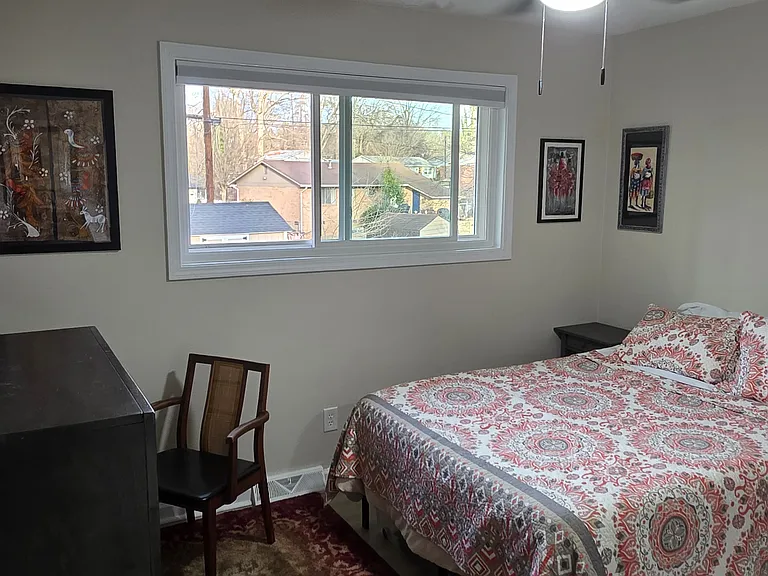 The full bedroom has an overhead fan/light, two nightstands, a chest of drawers, and a secondary desk/chair.