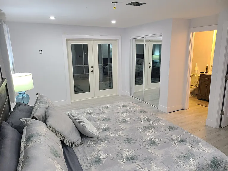 Master Bedroom looking West to the french doors leading to lanai