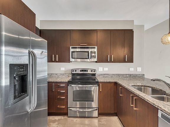 Kitchen opens to living/dining area