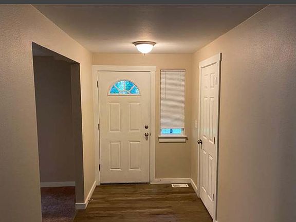 Hallway - Facing Front Door, Through Left Opening is the White Fireplace