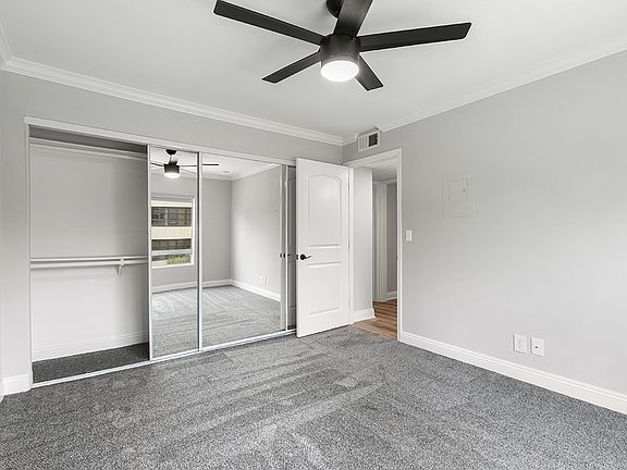 Carpeted Bedroom with Ceiling Fan.