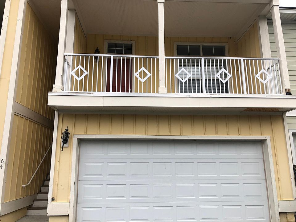 main entrance and 2 car garage with living room balcony